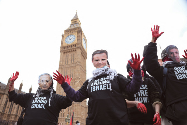  PRO-HAMAS protesters with red paint on their hands wear masks of UK Prime Minister Rishi Sunak, UK Foreign Secretary David Cameron, and Israeli Prime Minister Benjamin Netanyahu as they hold signs reading ‘Stop arming Israel,’ near Big Ben  in London, earlier this year. (credit: HOLLIE ADAMS/REUTERS)