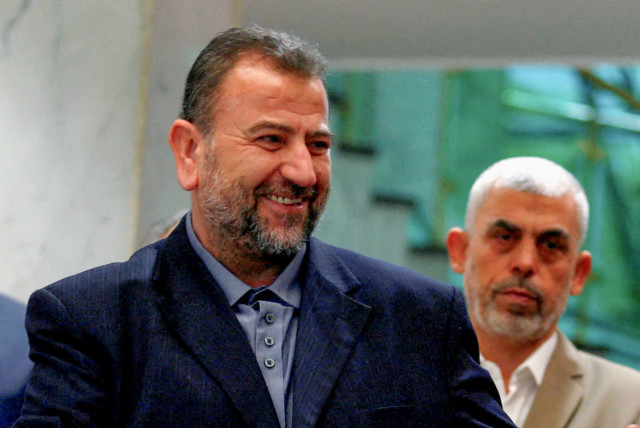  Head of Hamas delegation Saleh al-Arouri, with Gaza's Hamas leader Yahya Sinwar behind him, signs a reconciliation deal with Fatah leader Azzam Ahmad (not pictured), in Cairo, Egypt, October 12, 2017. (credit: REUTERS)