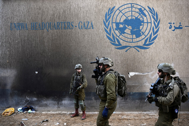  Israeli soldiers operate next to the UNRWA headquarters, amid the ongoing conflict between Israel and the Palestinian Islamist group Hamas, in the Gaza Strip, February 8, 2024.  (credit: DYLAN MARTINEZ/REUTERS)