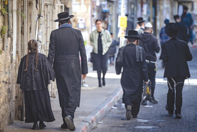  HAREDI JEWS walk in the streets of the ultra-Orthodox neighborhood of Mea Shearim, in Jerusalem, earlier this month. (credit: Chaim Goldberg/Flash90)
