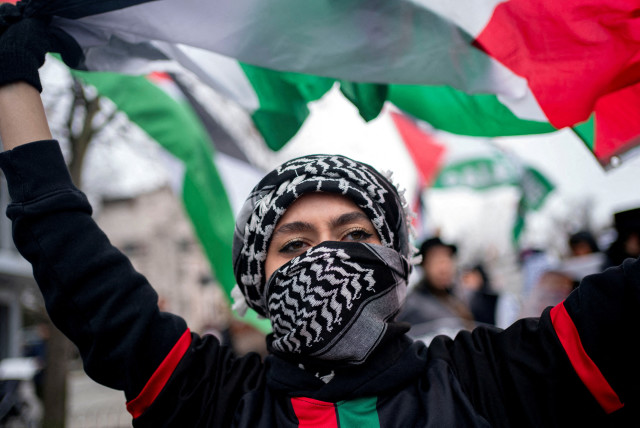  A pro-Palestinian demonstrator waves a Palestinian flag while marching to call for a ceasefire in Gaza, amid the ongoing conflict between Israel and the Palestinian Islamist group Hamas, during a protest in Washington, U.S., March 2, 2024. (credit: Bonnie Cash/Reuters)