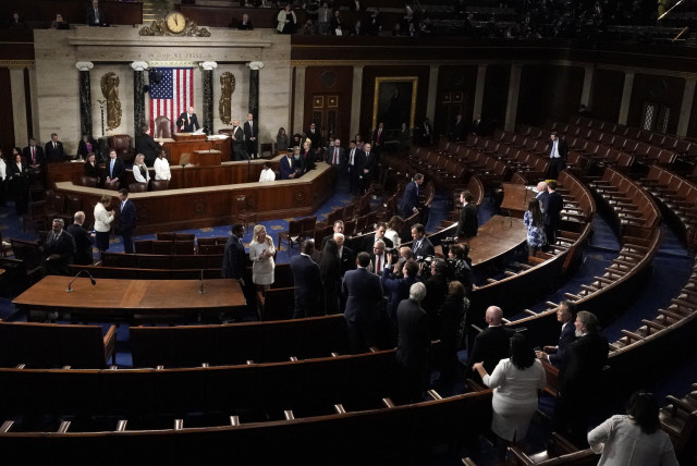  U.S. President Joe Biden remains in the nearly empty chamber greeting members of Congress following his State of the Union address at the U.S. Capitol in Washington, D.C., March 7, 2024.  (credit: REUTERS/ELIZABETH FRANTZ)