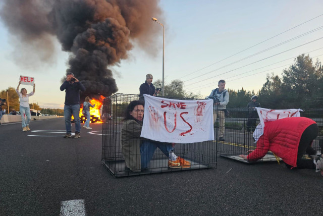  Families of the hostages protest government inaction in bringing the hostages home by burning tires on Highway 1, March 8, 2024. (credit: Hostage and Missing Families Forum)