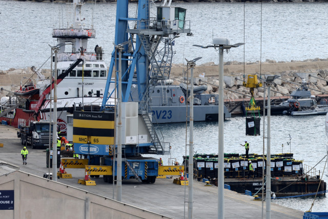  Humanitarian aid for Gaza is loaded onto platform in Larnaca, March 9, 2024 (credit: REUTERS/YIANNIS KOURTOGLOU)