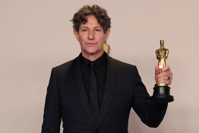  Director Jonathan Glazer poses with the Oscar for Best International Feature Film for ''The Zone of Interest'' of United Kingdom in the Oscars photo room at the 96th Academy Awards in Hollywood, Los Angeles, California, US, March 10, 2024.  (credit: REUTERS/CARLOS BARRIA)