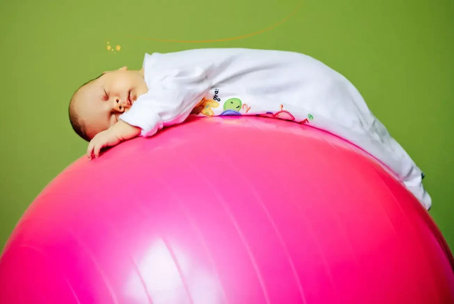   There's nothing like gentle bouncing on the ball to calm a gassy baby (credit: SHUTTERSTOCK)