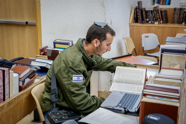  Israeli soldiers who were released for a short break from the war in the Gaza Strip against Hamas study Torah at the Har Etzion Yeshiva in the Jewish settlement of Alon Shvut, in Gush Etzion, on January 16, 2024.  (credit: GERSHON ELINSON/FLASH90)