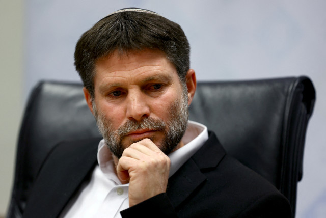   Israeli Finance Minister Bezalel Smotrich attends a news conference after announcing that he will sign an order to seize Palestinian Authority funds and transfer them to the families of victims of Palestinian attacks, at Israel's Finance Ministry in Jerusalem, January 8, 2023.  (credit: RONEN ZVULUN/REUTERS)