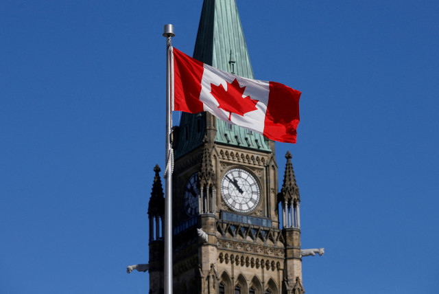  A Canadian flag flies in front of the Peace Tower on Parliament Hill in Ottawa, Ontario, Canada, March 22, 2017. (credit: CHRIS WATTIE/REUTERS)
