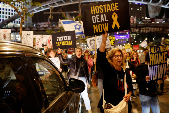  Demonstrators take part in a protest calling for the release of hostages, in Tel Aviv (credit: REUTERS/CARLOS GARCIA RAWLINS)
