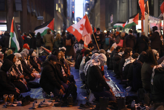  Supporters of a ceasefire in Gaza pray as they gather to protest outside the venue of a Liberal Party fundraising rally featuring Canada's Prime Minister Justin Trudeau, amid the ongoing conflict between Israel and the Palestinian Islamist group Hamas, in Toronto, Ontario, Canada, March 15, 2024.  (credit: REUTERS/CARLOS OSORIO)