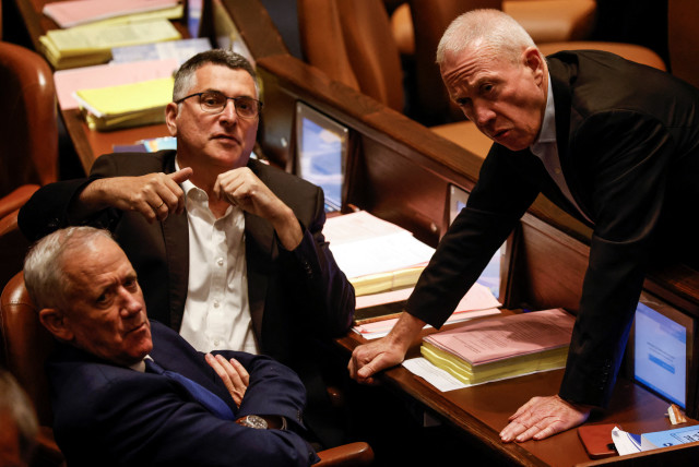  Israeli Defence Minister Yoav Gallant, Benny Gantz, head of National Unity, and opposition lawmaker Gideon Saar look on as lawmakers gather at the Knesset plenum to vote on a bill that would limit some Supreme Court power, in Jerusalem July 24, 2023.  (credit: AMIR COHEN/REUTERS)