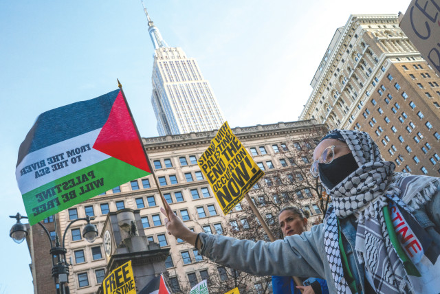  AT A protest in New York City in December, a flag carries the slogan, ‘From the river to the sea, Palestine will be free.’ Seemingly intelligent people resurrect the two-state solution delusion, while ignoring the incessant cries for a one-state solution, the writer argues. (credit: Eduardo Munoz/Reuters)