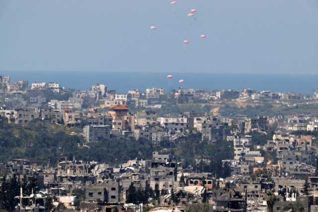  Humanitarian aid falls through the sky towards the Gaza Strip after being dropped from an aircraft, amid the ongoing conflict between Israel and the Palestinian Islamist group Hamas, as seen from Israel's border with Gaza, in southern Israel, March 20, 2024. (credit: AMIR COHEN/REUTERS)