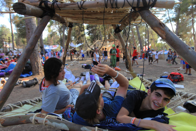  The ''Tzofim''- young Israeli scouts, play at    a summer camp in the Haruvit forest near Kfar Menahem on July 7 2009. (Illustrative of American Jewish summer camps.) (credit: NATI SHOHAT/FLASH90)