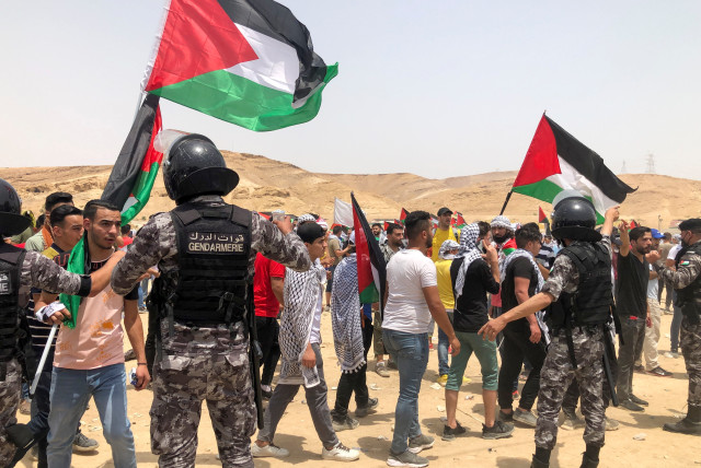  Members of the Jordanian Gendarmerie stand guard during a demonstration to express solidarity with the Palestinian people and to celebrate following Israel-Hamas truce, in Karameh, Jordan valley, Jordan May 21, 2021. (credit: JEHAD SHELBAK/REUTERS)