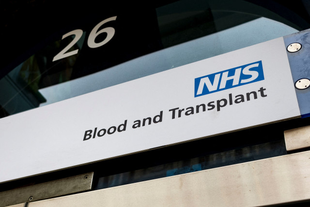 An NHS Blood and Transplant sign is seen at the Blood Donor Center, following the announcement of the re-balloting voted in the long-running dispute over pay and staffing, in London, Britain, February 18, 2023. (credit: MAY JAMES/REUTERS)