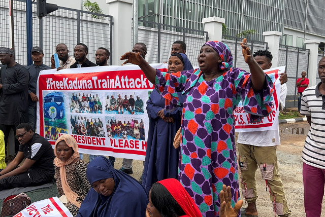  A woman points at the picture of her kidnapped daughter as relatives of the Kaduna train kidnapped victims protest, following the threat from bandits to kill the victims if ransom demand is not paid, at the ministry of transport in Abuja, Nigeria July 25, 2022.  (credit: REUTERS/AFOLABI SOTUNDE)