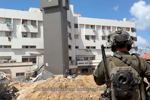  An Israeli soldier stands near al-Shifa hospital, where the Israeli army says weapons were found, in Gaza City, in this still image taken from video released on March 25, 2024.  (credit: Israel Defense Forces/Handout via REUTERS)