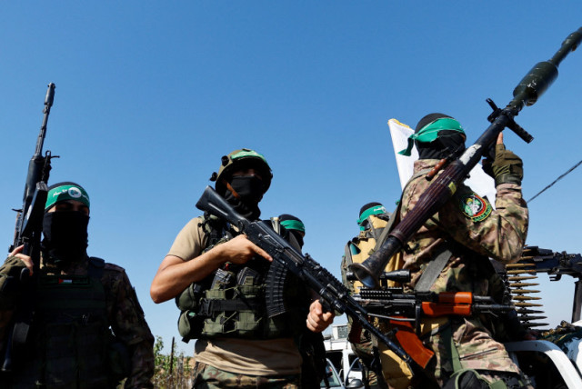  Combatientes palestinos del brazo armado de Hamás participan en un desfile militar con motivo del aniversario de la guerra de 2014 con Israel, cerca de la frontera en el centro de la Franja de Gaza, 19 de julio de 2023. (credit: REUTERS/IBRAHEEM ABU MUSTAFA)