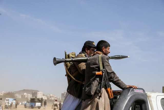  Armed Houthi followers ride on the back of a pick-up truck during a parade in solidarity with the Palestinians in the Gaza Strip and to show support to Houthi strikes on ships in the Red Sea and the Gulf of Aden, in Sanaa, Yemen January 29, 2024.  (credit: KHALED ABDULLAH/REUTERS)