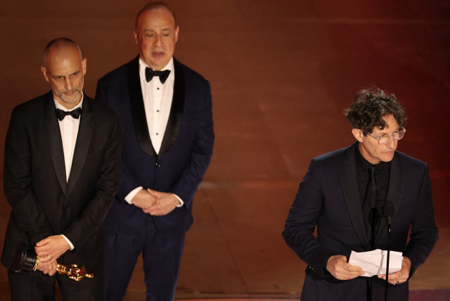  Director Jonathan Glazer, of the United Kingdom, accepts the award for Best International Feature Film for ''The Zone of Interest,'' during the Oscars show at the 96th Academy Awards in Hollywood, Los Angeles, California, U.S., March 10, 2024.  (credit: MIKE BLAKE/REUTERS)