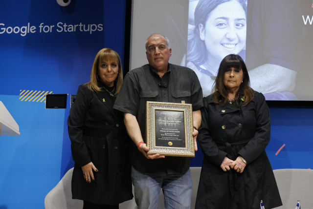  Eyal Eshel (center) receives the Woman of Valor award on behalf of his daughter, the late Sgt. Roni Eshel on March 27, 2024 (credit: MARC ISRAEL SELLEM)
