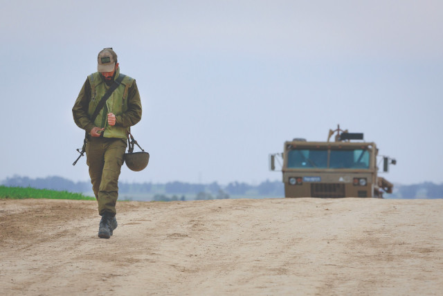  A SOLDIER walks near an IDF Artillery Corps staging area on the  border with Gaza (credit: MOSHE SHAI/FLASH90)