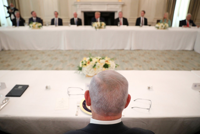  Israel Prime Minister Benjamin Netanyahu looks at U.S. President Donald Trump and other party officials during a luncheon in the State Dining Room following the Abraham Accords Signing Ceremony at the White House in Washington, U.S., September 15, 2020. (credit: TOM BRENNER/REUTERS)
