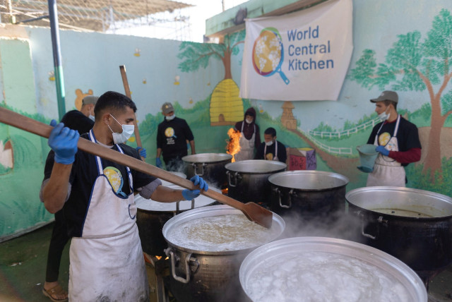  Members of ''World Central Kitchen'' prepare food for Palestinians, in the location given as Gaza, amid the ongoing conflict between Israel and Hamas, in this picture released on March 21, 2024 and obtained from social media.  (credit: @chefjoseandres via X/via REUTERS )