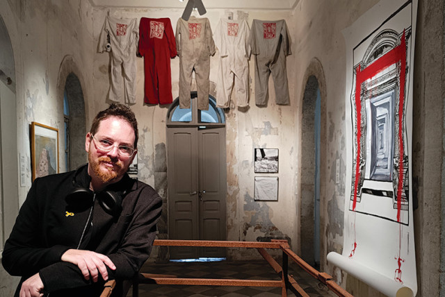  Elad Yaron, curator of ‘Forsaken Zone,’ with the now-rusty and broken metal ‘Holy Ark’ by Guy David Briller (credit: HaMiffal)