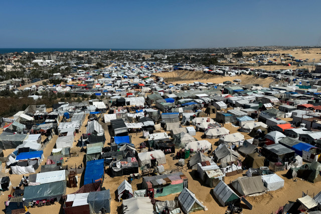  Displaced Palestinians, who fled their houses due to Israeli strikes, shelter in a tent camp, amid the ongoing conflict between Israel and the Palestinian Islamist group Hamas, in Rafah, in the southern Gaza Strip March 11, 2024. (credit: REUTERS/BASSAM MASOUD)