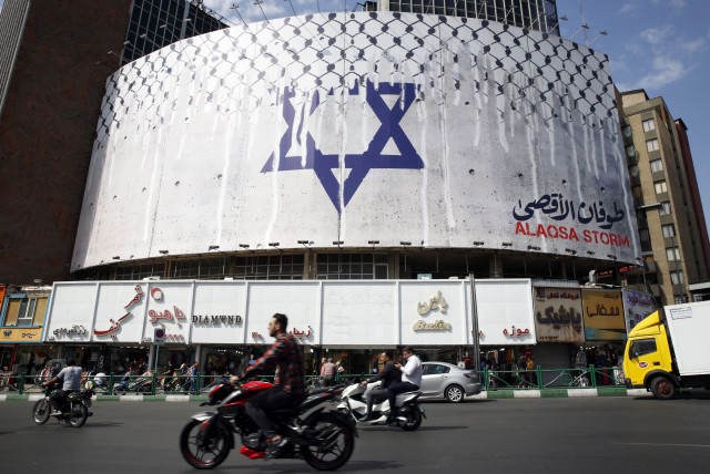  ANTI-ISRAEL billboard – with a checkered keffiyeh covering the Star of David, titled ‘Operation Al-Aqsa Flood’ – takes pride of place in Tehran’s central Vali Asr Square, Oct. 8, 2023.  (credit: AFP VIA GETTY IMAGES)