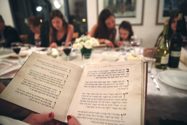  NO MATTER what traditions people bring to the Seder, the constant is the Haggadah. (credit: YAHAV GAMLIEL/FLASH90)