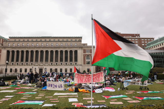  Demonstrators sit in an encampment as they protest in solidarity with Pro-Palestinian organizers on the Columbia University campus, amid the ongoing conflict between Israel and Hamas, in New York City, US. April 19, 2024. (credit: CAITLIN OCHS/REUTERS)