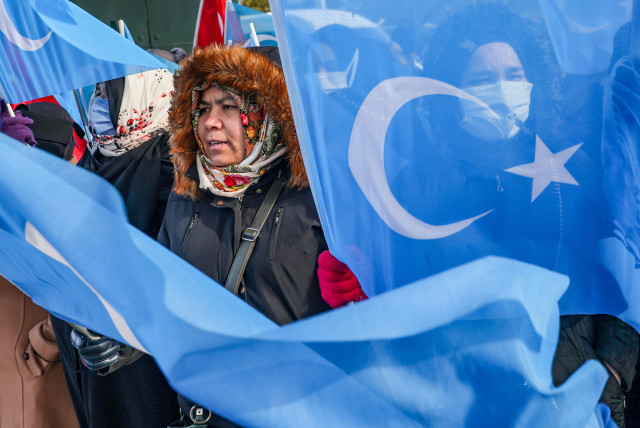  People from China's Uyghur Muslim ethnic group protest outside the city's Turkish Olympic Committee building, n Istanbul, Turkey, January 23, 2022.   (credit: REUTERS/UMIT BEKTAS)