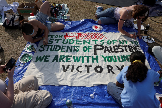  Students at Columbia University paint a response to a message written by Palestinians in Rafah thanking students for their support as they continue to maintain a protest encampment on campus in support of Palestinians, during the war between Israel and Hamas, April 28, 2024.  (credit: REUTERS/CAITLIN OCHS)