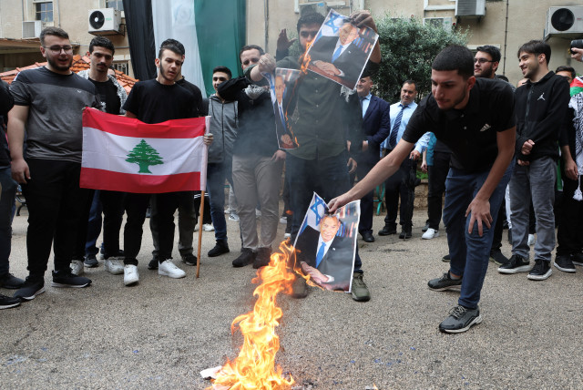  A demonstrator burns a picture depicting Israeli Prime Minister Benjamin Netanyahu during a protest in solidarity with Gaza at the Lebanese American University (LAU), in Beirut, Lebanon April 30, 2024. (credit: REUTERS/MOHAMED AZAKIR)