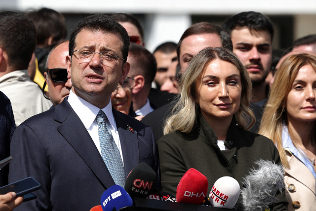  Istanbul Mayor Ekrem Imamoglu, mayoral candidate of the main opposition Republican People's Party (CHP), accompanied by his wife Dilek Imamoglu, talks to media after casting his vote during the local elections in Istanbul, Turkey March 31, 2024. (credit: REUTERS/MURAD SEZER)