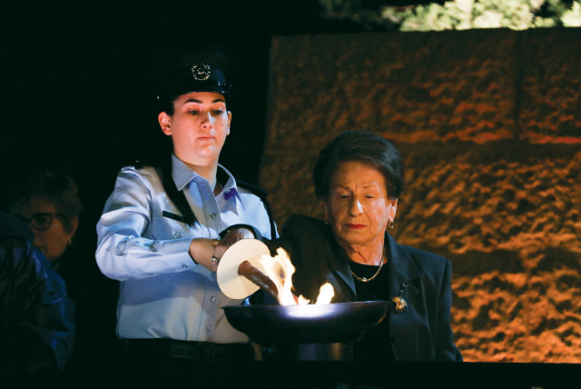  A SURVIVOR lights a torch at Yad Vashem on Holocaust Remembrance Day 2021.  (credit: OLIVIER FITOUSSI/FLASH90)