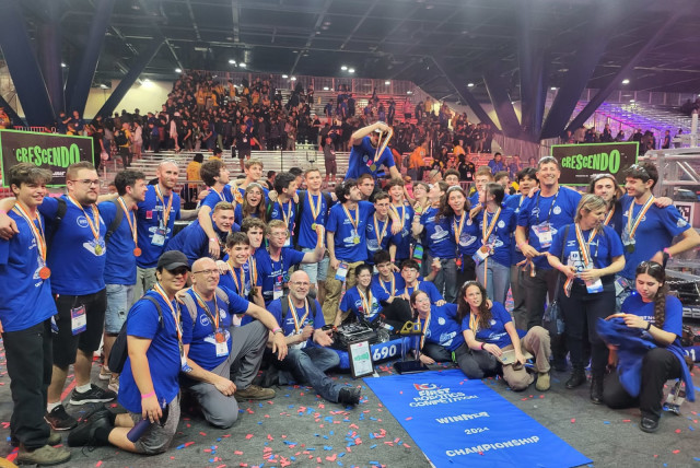  FRC Team Orbit #1690 taking a picture with the banner showing they won first place in the world championship in Texas. Uploaded on 4/5/2024 (credit: FIRST ISRAEL)