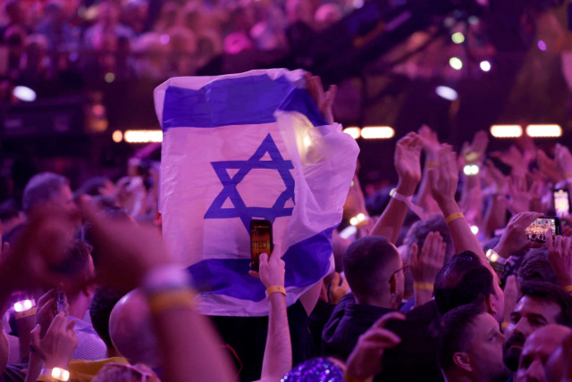  A member of the audience holds an Israeli flag during the second semi-final of the 2024 Eurovision Song Contest, in Malmo, Sweden, May 9, 2024. (credit: Leonhard Foeger/Reuters)