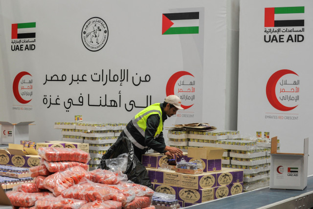 A volunteer from Emirates Red Crescent prepares parcels with humanitarian aid for Gaza to be transferred through the Rafah border crossing between Egypt and the Gaza Strip, in Cairo, Egypt, March 30, 2024. (credit: REUTERS/SHOKRY HUSSEIN)