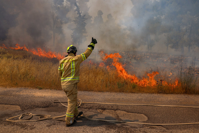  Firefighters at the site of a fire that started from missiles launched from Lebanon, at the Biriya Forest in northern  Israel, on June 13, 2024 (credit: David Cohen/Flash90)