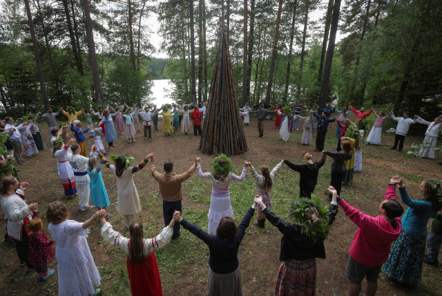  People attend Ivan Kupala festival, marking the day of the summer solstice, in Leningrad Region, Russia June 20, 2024. (credit: REUTERS/ANTON VAGANOV)