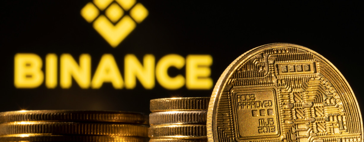  A representation of the cryptocurrency is seen in front of Binance logo in this illustration taken, March 4, 2022. 