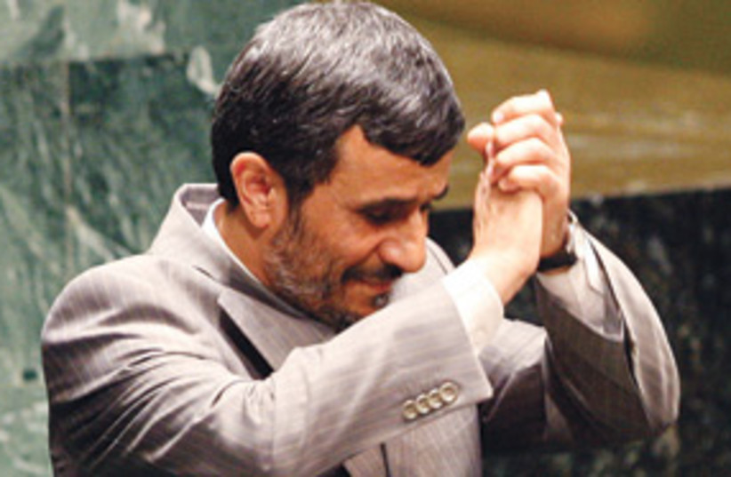 ahmadinejad hand clap 311 (photo credit: AP)