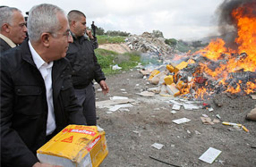 fayyad burn israeli products fire 311 (photo credit: Associated Press)
