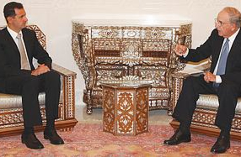 Mitchell and Assad (photo credit: Associated Press)