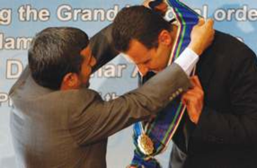 Assad Ahmadinejad Medal 311 AP (photo credit: Associated Press)
